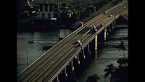 aerial view of 17th Street,Causeway Bridge opening for boats of Miami Beach,Florida. Cars in the traffic in the popular seafront in 70's. Historical United States of America in 1979.