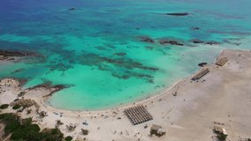 Aerial drone panoramic view video of famous exotic paradise sandy deep emerald beach of Elafonissi in South West Crete island, Greece