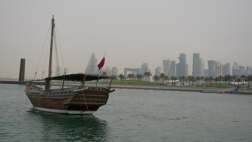 The Corniche promenade opens the view on scenic wooden dhow boats, moored in Doha harbor, Qatar