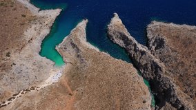 Aerial drone video of paradise turquoise rocky beach in shape of fjord of Seitan limania or Agiou Stefanou, Chania - Akrotiri, Crete, Greece