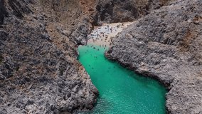 Aerial drone video of paradise turquoise rocky beach in shape of fjord of Seitan limania or Agiou Stefanou, Chania - Akrotiri, Crete, Greece