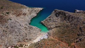 Aerial drone video of volcanic exotic rocky island beach in shape of fjord with turquoise clear sea