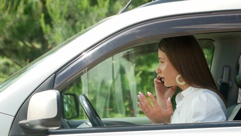 A woman calling for help near her broken car, Business woman calling for help from your mobile phone