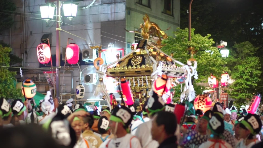 crowd dancing and chanting at a japanese festival & carrying a portable shrine, huge crowd of of people participanting at a japanese festival
