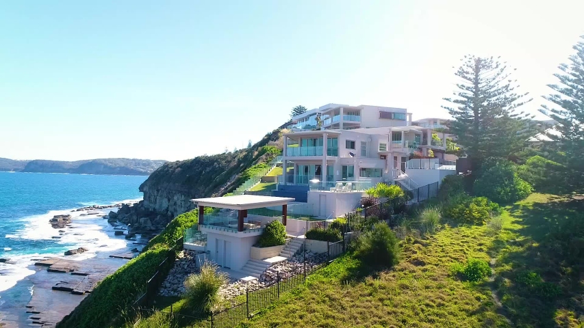 luxury house on the cliff hill, close up flying backward
