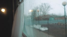 the view from the train window, the rain on the window of the car window. people walk along the railway. train railway trip Russia winter. slow motion video. concept interior inside lifestyle train