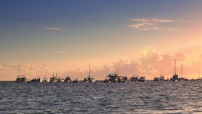Sunrise over yachts, catamarans and boat in tropical caribbean sea. Summer holidays on island