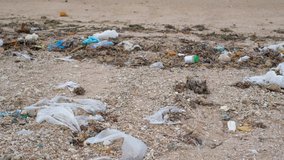 Trash, plastic, garbage, bottle... environmental pollution on the beach.  video footage of trash, plastic bottle on the beach. Waste that polluted the ocean environment