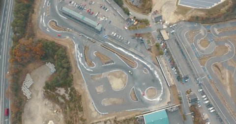 Direct Overhead Aerial Drone Shot of a Busy Drift Race Track with an Interstate in the Background.