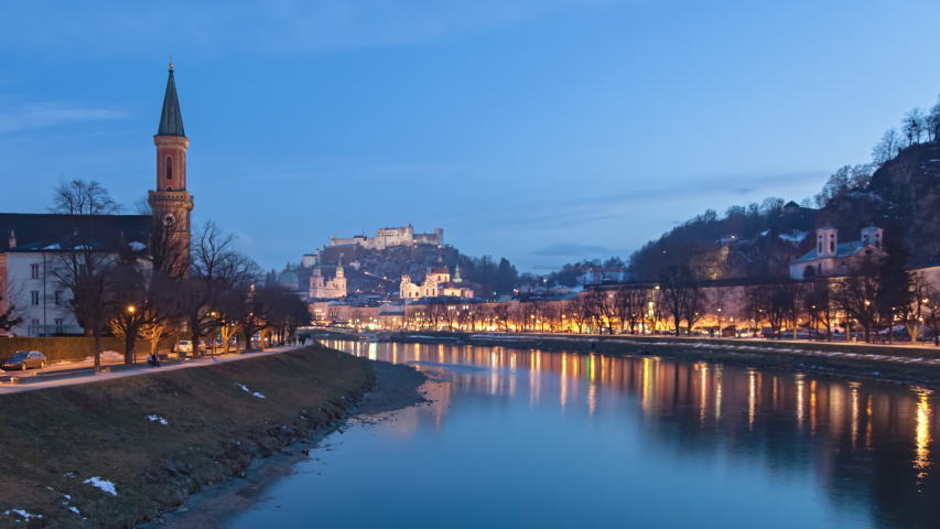Winter evening hyper lapse of Salzburg old town, Hohensalzburg Fortress, Salzburg Christuskirche and Salzach riverside, Austria.