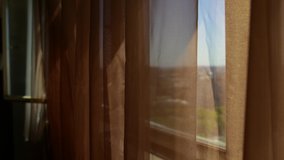 Moving brown transparent voile at wide open window - Powered by Shutterstock - Get 15% off with code: PIKWIZARD15