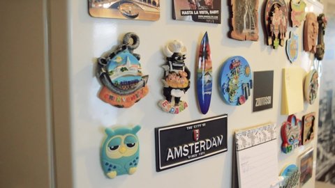 Ladice, Slovakia - 11 29 2018: Souvenir magnets from different places from around the world on a fridge at home