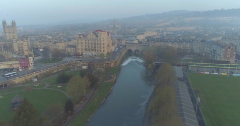Rising aerial of the Historic Roman city of Bath Spa in England / the United Kingdom over Pultney Bridge
