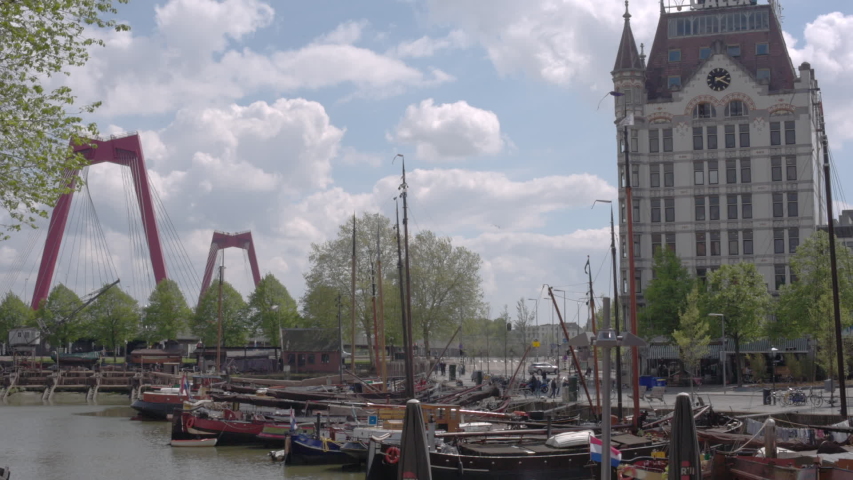 Rotterdam Cityscape of Old Harbour, historic ships in the dockyard,  Willemsbrug bridge traditional Dutch buildings on a sunny day in Rotterdam, South Holland, the Netherlands