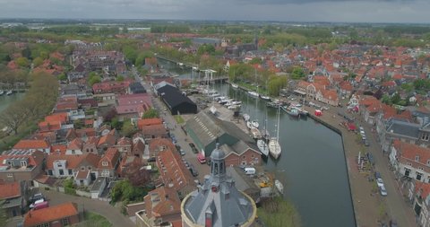 Aerial pulling back from the Drommedaris Defence tower in historic Dutch town Enkhuizen in North Holland the Netherlands