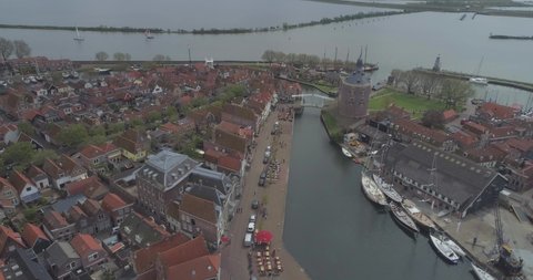 Aerial of historic Dutch town Enkhuizen in North Holland the Netherlands approaching the port aera and Drommedaris Defence tower