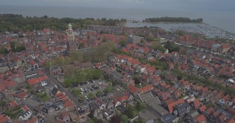 Aerial of traditional buildings and rooftops in historic Dutch town Enkhuizen in North Holland the Netherlands with the port and sea in the background