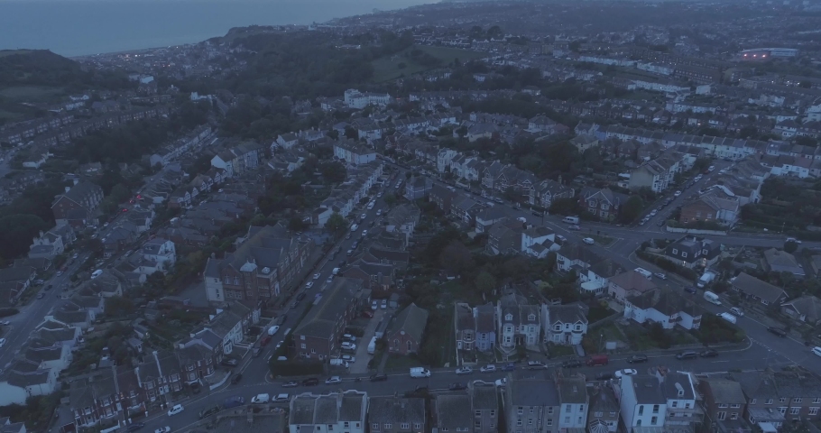Night aerial tilting down over residential houses in Hastings, England, United Kingdom Royalty-Free Stock Footage #1030886522