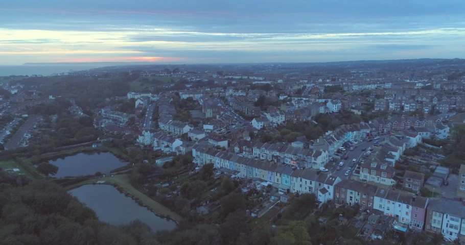 Sunset aerial over residential houses in Hastings, England, United Kingdom Royalty-Free Stock Footage #1030886528