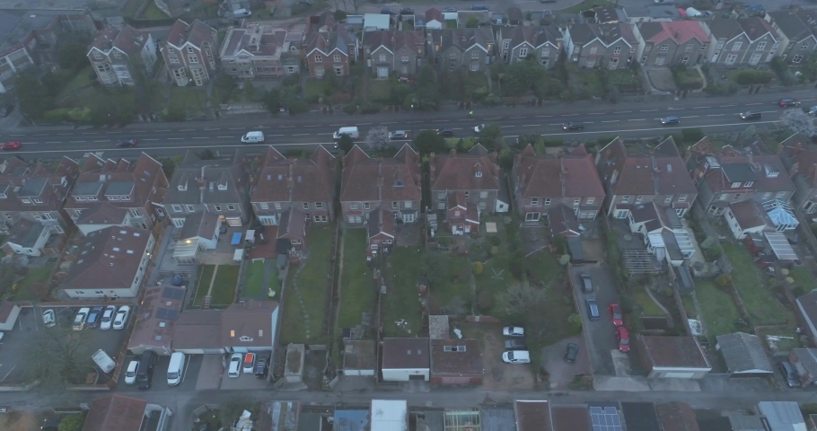 Top down aerial tracking along residential houses gardens and garages beside road in South Bristol England Royalty-Free Stock Footage #1030886594