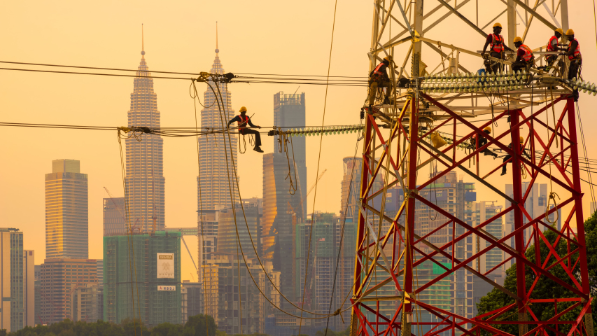 Time lapse of electricians in silhouette working on a new power transmission tower as part of the nation power grid. Dramatic scene. Kuala Lumpur, Malaysia Royalty-Free Stock Footage #1030886873