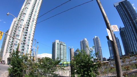 Toronto, Ontario, Canada May 2019 POV driving tilt up downtown Toronto business and financial district buildings