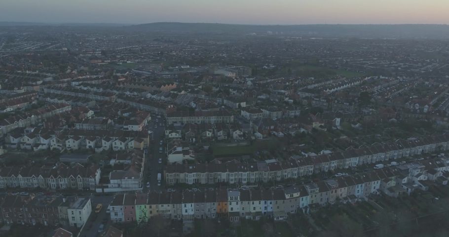 Evening aerial tracking past rows of coloured terraced suburban houses in South Bristol UK Royalty-Free Stock Footage #1030893716