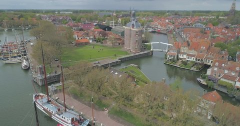 Aerial descending past sailing boats in in historic Dutch town Enkhuizen in North Holland the Netherlands