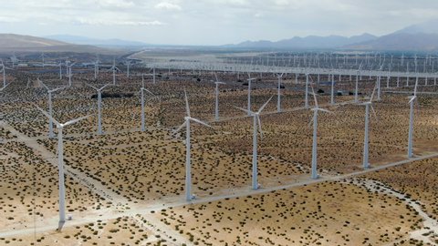 Aerial view of wind turbines generating electricity. Huge array of gigantic wind turbines spreading over the desert in Palm Springs wind farm, California, USA 