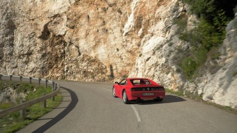 Saint Paul De Vence, France - 10 13 2018: Folllowing a red Ferrari 348 on the winding mountain roads and tunnels of France during the Boucle Historique vintage sports car rally.