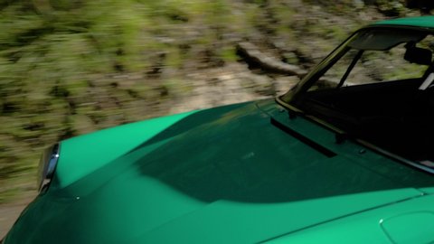Saint Paul De Vence, France - 10 13 2018: A bright green vintage Porsche 911 sports car driving along the roads of France during the Boucle Historique vintage sports car rally.