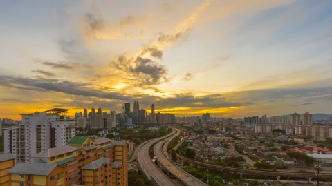 Time Lapse: Day to night of cityscape during a golden sunset overlooking an elevated highway in Kuala Lumpur city in Malaysia. Pan down motion timelapse. 스톡 비디오