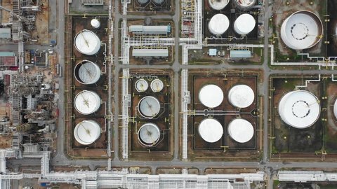 Aerial top down view over oil refinery and power plant with many storage tanks and pipelines. Shot with 4K UHD resolution drone.
