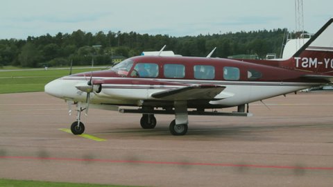 Pilot Attempting to Start Turboprop Engines. First Attempt Does Not Work Causing Pilot to Try Again a Second Time. Plane Preparing for Take Off from a Small Airfield on a Clear, Sunny Day.