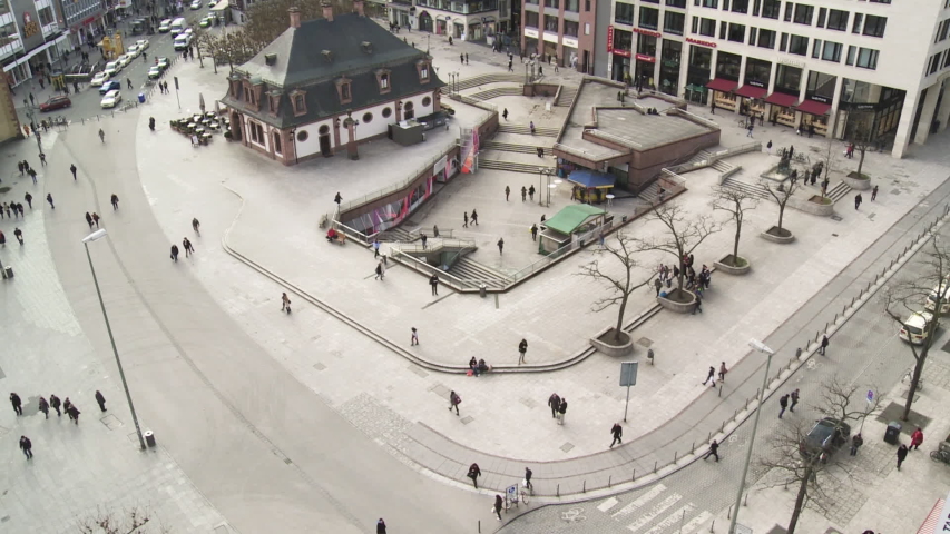 Street camera view of people activity in pedestrian zone of Frankfurt. Wide shot. 