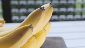Ripe banana fruit on wooden table. Selective focus. Panning to the left.