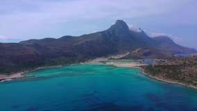 Aerial drone view video of iconic Balos beach and lagoon near Gramvousa island with turquoise clear sea and pure white sand, Crete island, Greece