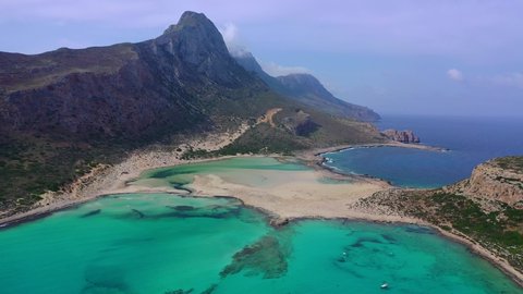 Aerial drone view video of iconic Balos beach and lagoon near Gramvousa island with turquoise clear sea and pure white sand, Crete island, Greece