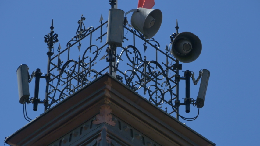 View of outdoor megaphone on the tower of a building.
