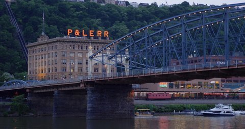 PITTSBURGH - Circa June, 2019 - An evening establishing shot view of the historic Pittsburgh and Lake Erie Railroad building (P&LERR) in tourist district of Pittsburgh. The Smithfield Street Bridge in