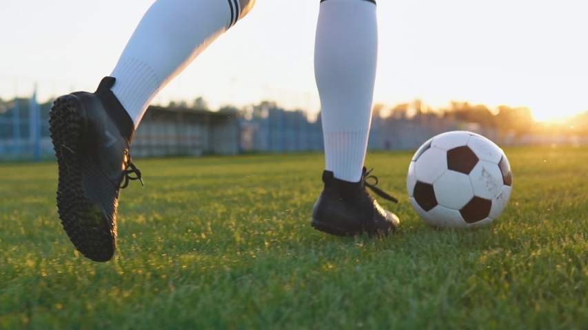 Close up of female football player running and kicking soccer ball at sunset in slow motion | Shutterstock HD Video #1030949561