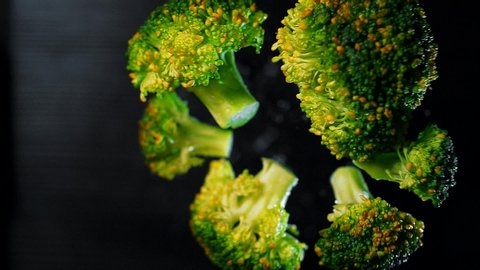 Juicy green broccoli hover in the air in super slow motion. Macro shoting. Food Porn video.