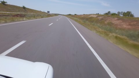 Panoramic view outside of a car driving on a highway in Morocco.