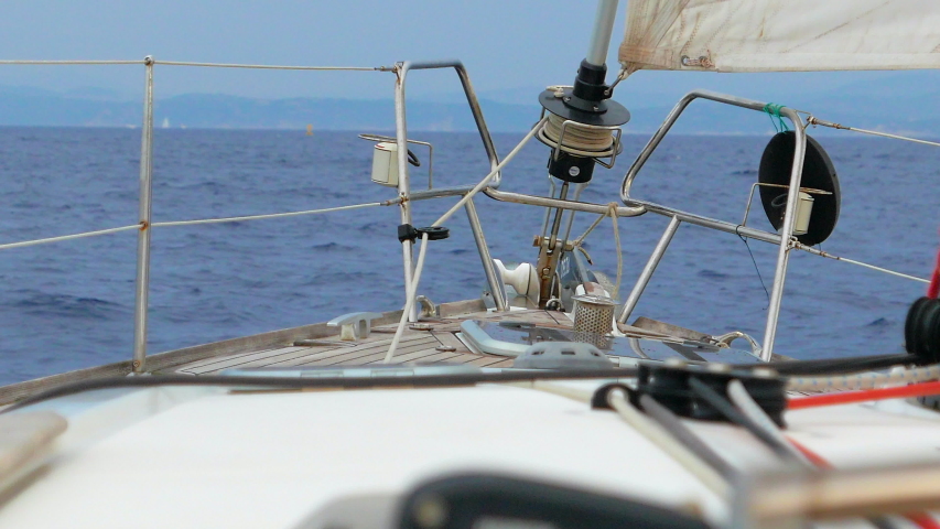View from the bow of a sailing boat in the mediterannean sea in the summer