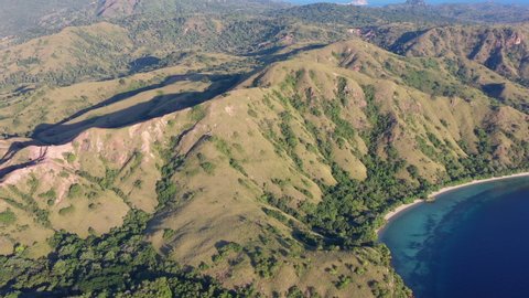 The rugged island of Rinca is surrounded by a fringing coral reefs in Komodo National Park, Indonesia. This tropical area is known for both its marine biodiversity as well as its infamous dragons.