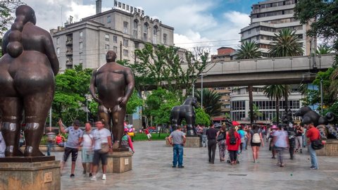Medellin, Colombia - November 6: Zoom out time lapse view of Botero Square (Plaza Botero) showing people and outdoor sculptures by renowned Colombian artist Fernando Botero in Medellin, Colombia.