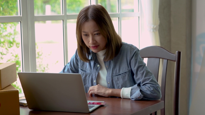 Beautiful Asian women are buying products online and paying with credit cards.