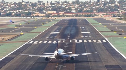 San Diego, California / United States - 12 08 2018: Timelapse of planes entering in a runway and taking off in Lindbergh Field in San Diego