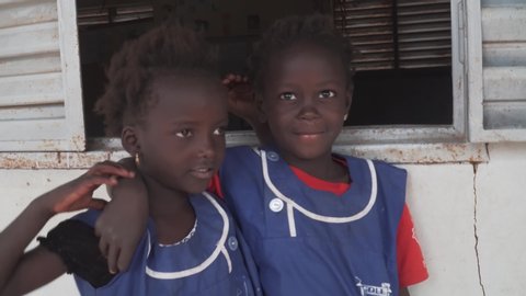 Thies, Thies / Senegal - 02 16 2018: Two little Senegalese pupils smiling into the camera. Wearing their school uniform.