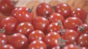 Close up footage of cherry tomatoes. Selective focus. Panning to the left.